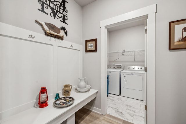 mudroom with marble finish floor and washer and clothes dryer