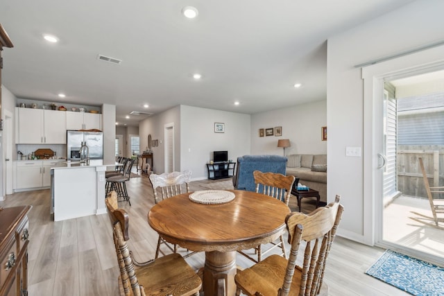 dining area with visible vents, recessed lighting, light wood finished floors, and baseboards