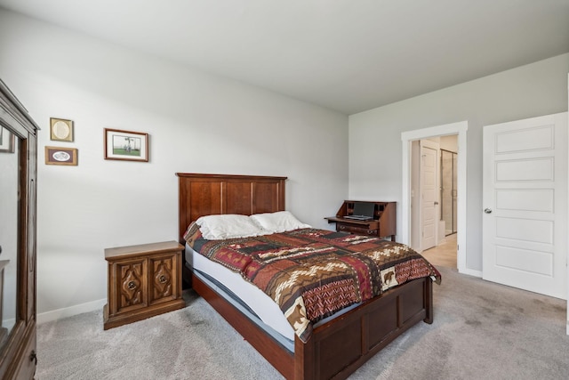 bedroom with baseboards and light colored carpet