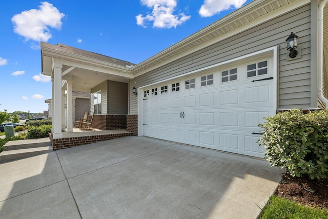 garage featuring concrete driveway