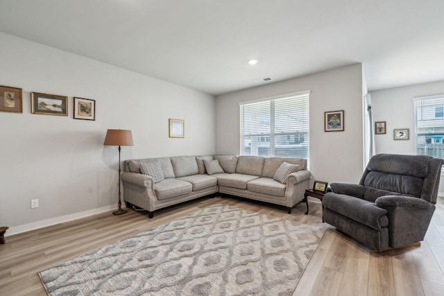 living area with recessed lighting, baseboards, light wood-type flooring, and visible vents