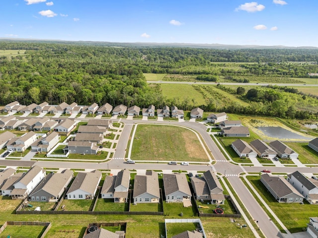 birds eye view of property featuring a residential view and a wooded view