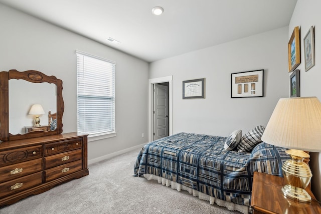 bedroom with baseboards, carpet, and visible vents