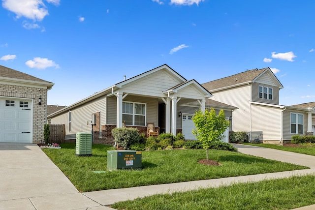 view of front of home featuring driveway, central AC unit, a garage, brick siding, and a front lawn