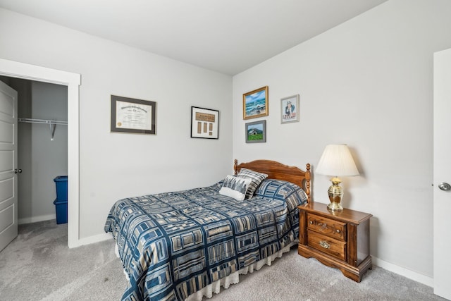 bedroom with carpet floors, baseboards, a spacious closet, and a closet