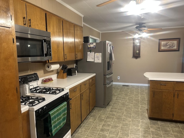 kitchen with crown molding, a ceiling fan, appliances with stainless steel finishes, and brown cabinets
