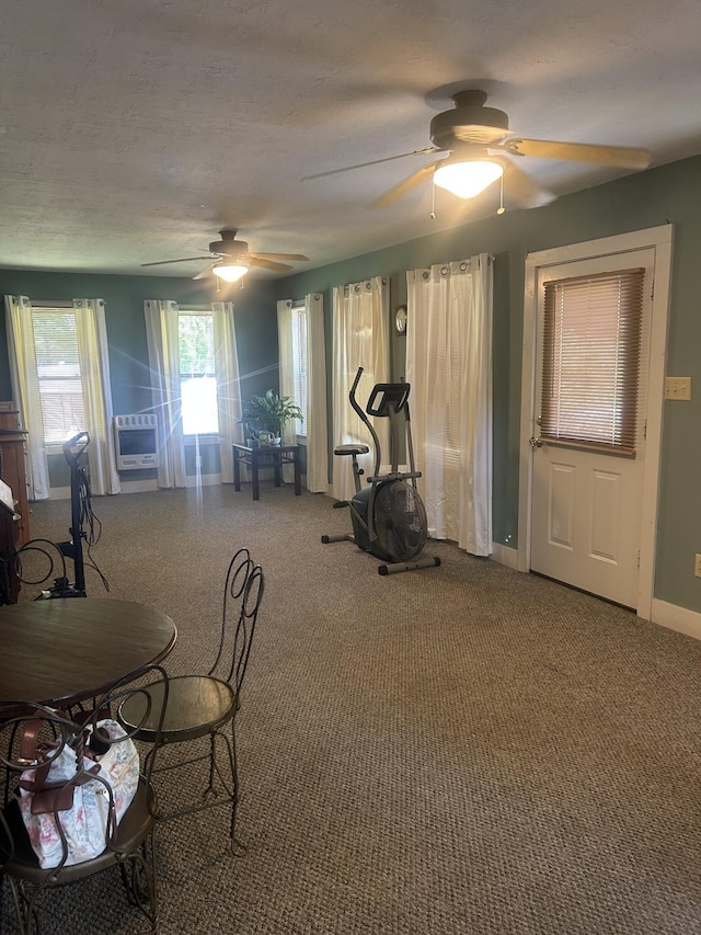 workout room with carpet flooring, a ceiling fan, and baseboards