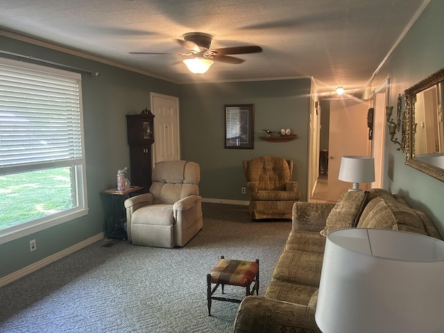 carpeted living area with baseboards, ornamental molding, and ceiling fan