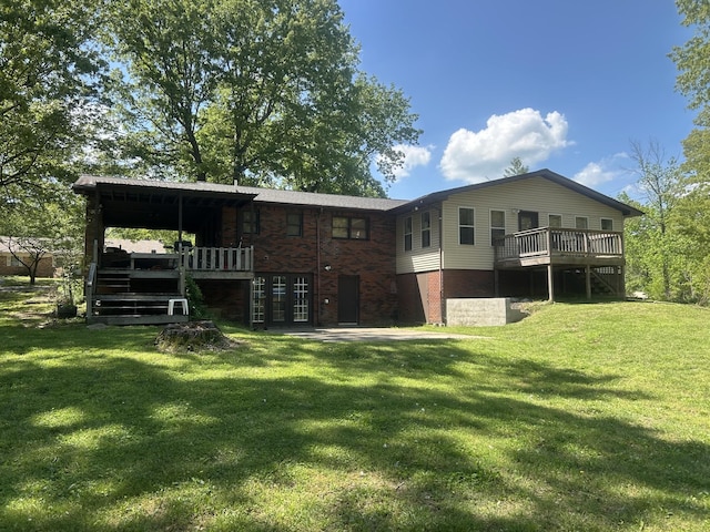 rear view of house featuring a yard, stairway, and a wooden deck