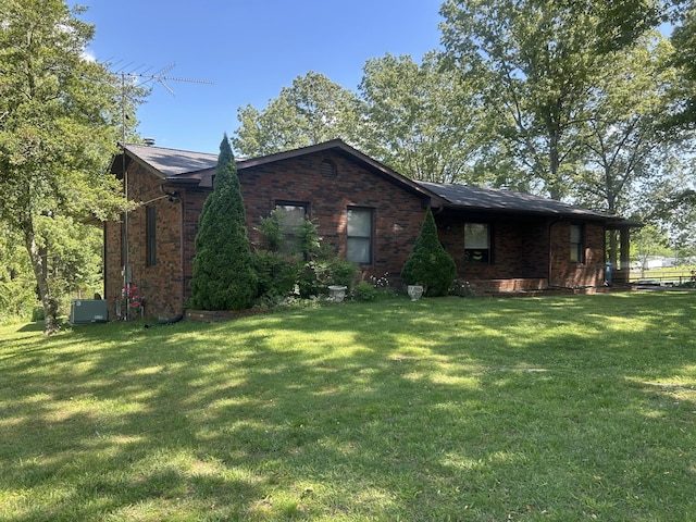 view of front of house with brick siding and a front lawn
