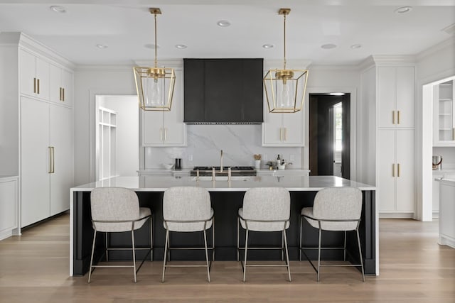 1105 Brookmeade Dr, Nashville, TN 37204 - kitchen featuring light countertops, tasteful backsplash, ornamental molding, and light wood-style flooring