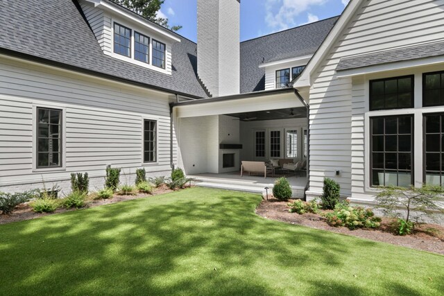 1105 Brookmeade Dr, Nashville, TN 37204 - back of house with a shingled roof, a patio area, a yard, and a chimney