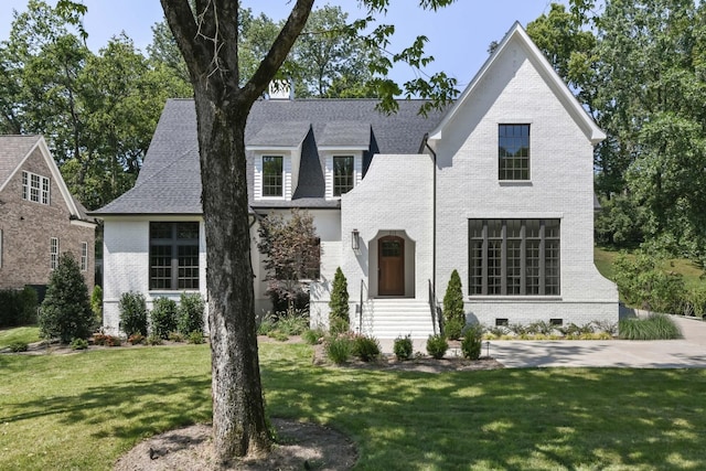 1105 Brookmeade Dr, Nashville, TN 37204 - tudor house featuring brick siding, crawl space, a shingled roof, and a front yard