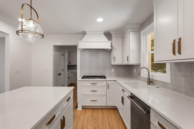 6556 Jocelyn Hollow Rd, Nashville, TN 37205 - kitchen with a sink, light countertops, premium range hood, stainless steel appliances, and white cabinetry