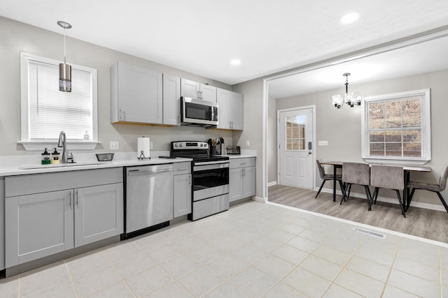 2821 Old Matthews Rd, Nashville, TN 37207 - kitchen with visible vents, a sink, gray cabinets, and stainless steel appliances