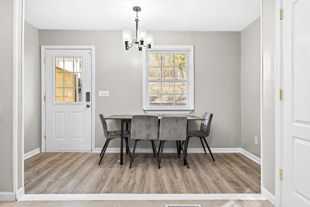 2821 Old Matthews Rd, Nashville, TN 37207 - dining space with baseboards, visible vents, wood finished floors, and a chandelier