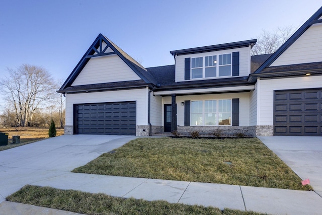view of front of property with a garage, driveway, and a front lawn