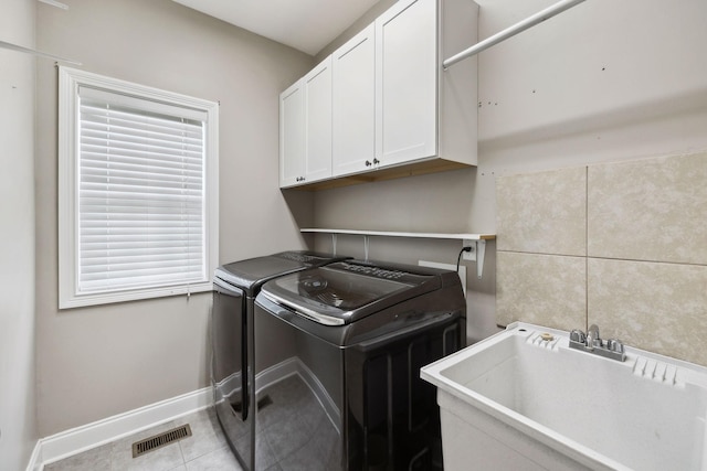 1353 Stewart Creek Rd, Murfreesboro, TN 37129 - clothes washing area featuring cabinet space, washing machine and clothes dryer, baseboards, and tile patterned floors