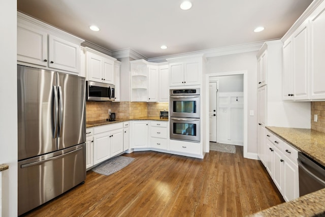 1353 Stewart Creek Rd, Murfreesboro, TN 37129 - kitchen featuring appliances with stainless steel finishes, white cabinetry, light stone countertops, decorative backsplash, and ornamental molding
