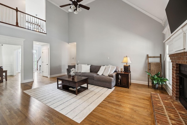 1353 Stewart Creek Rd, Murfreesboro, TN 37129 - living room with a fireplace, ceiling fan, high vaulted ceiling, wood finished floors, and crown molding