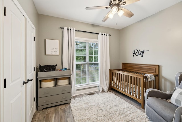 1353 Stewart Creek Rd, Murfreesboro, TN 37129 - bedroom featuring wood finished floors, a crib, a ceiling fan, and a closet
