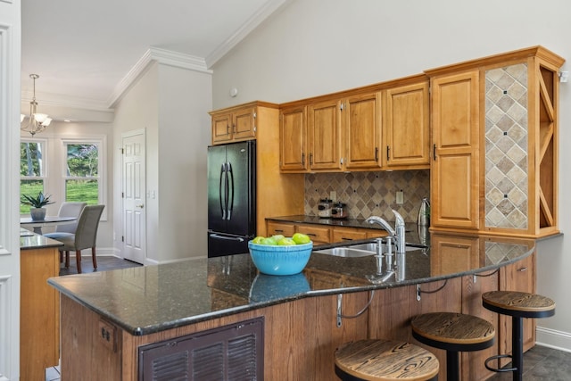 1403 Sneed Rd W, Franklin, TN 37069 - kitchen with freestanding refrigerator, brown cabinets, baseboards, and a sink