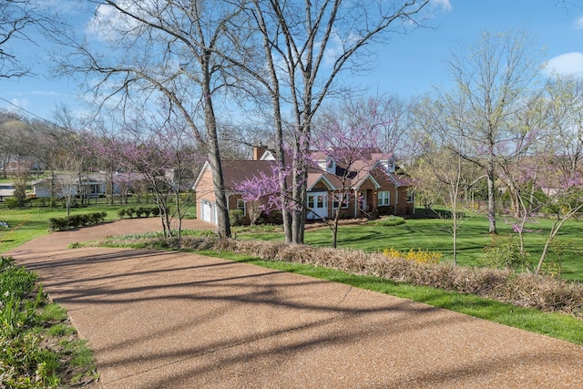 1403 Sneed Rd W, Franklin, TN 37069 - view of front of home featuring a garage, a front lawn, a chimney, driveway, and a residential view