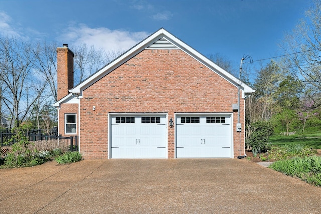 1403 Sneed Rd W, Franklin, TN 37069 - view of side of home with a garage, a chimney, concrete driveway, and brick siding