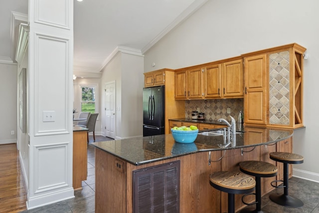 1403 Sneed Rd W, Franklin, TN 37069 - kitchen featuring freestanding refrigerator, beverage cooler, baseboards, tasteful backsplash, and a sink