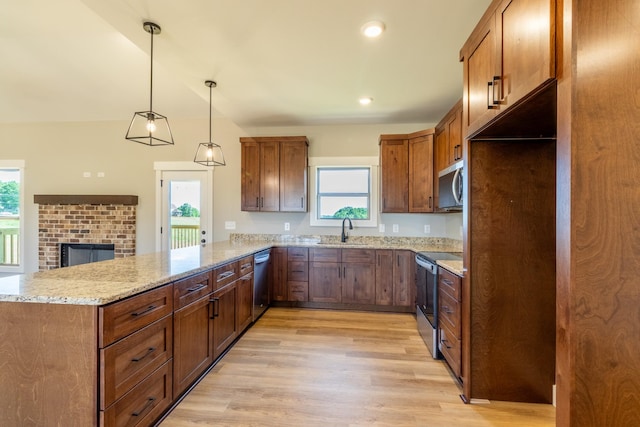 5367 Roy Holman Rd, Springfield, TN 37172 - kitchen with stainless steel appliances, a sink, a peninsula, light wood-style floors, and plenty of natural light