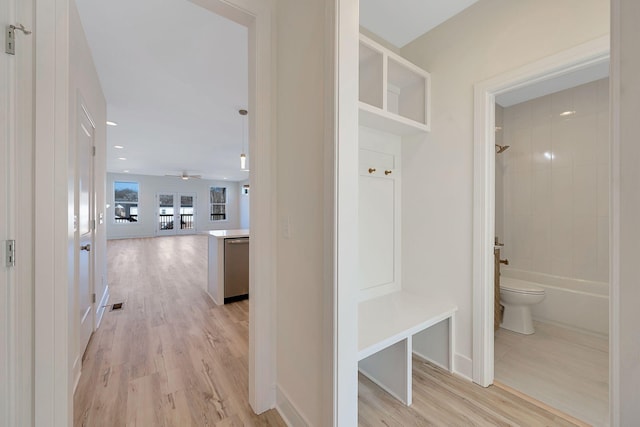 mudroom with light wood-style flooring, baseboards, and a ceiling fan