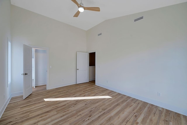 unfurnished bedroom with high vaulted ceiling, baseboards, light wood finished floors, and a ceiling fan