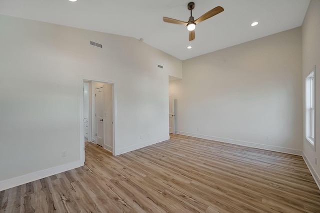 unfurnished room featuring a ceiling fan, baseboards, light wood finished floors, recessed lighting, and high vaulted ceiling