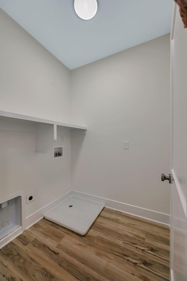 washroom with wood finished floors, hookup for a washing machine, electric dryer hookup, and baseboards