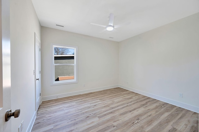 empty room with light wood finished floors, baseboards, and a ceiling fan