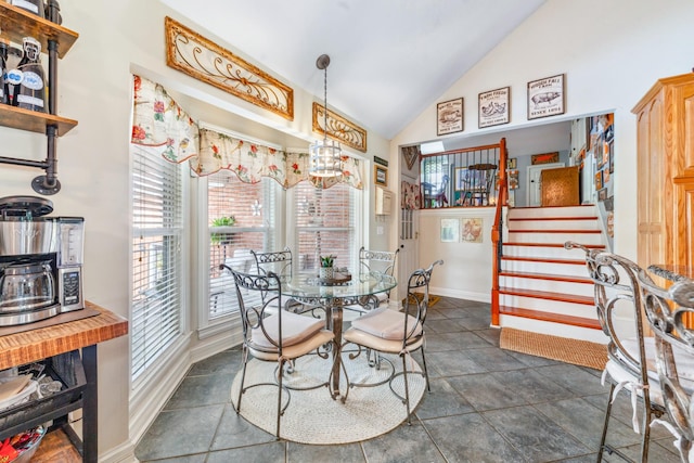 dining area with baseboards, vaulted ceiling, and stairway