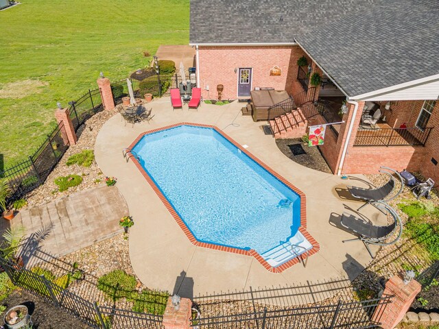 view of swimming pool with outdoor lounge area, a fenced backyard, a fenced in pool, a patio area, and a lawn
