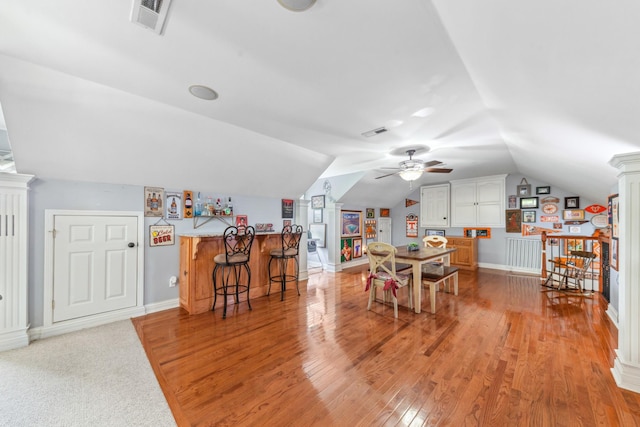 game room featuring visible vents, a ceiling fan, light wood-style floors, and vaulted ceiling