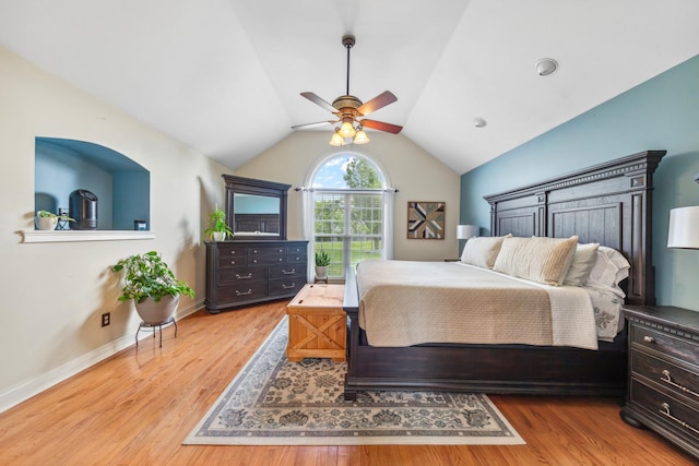 bedroom featuring baseboards, ceiling fan, vaulted ceiling, and wood finished floors