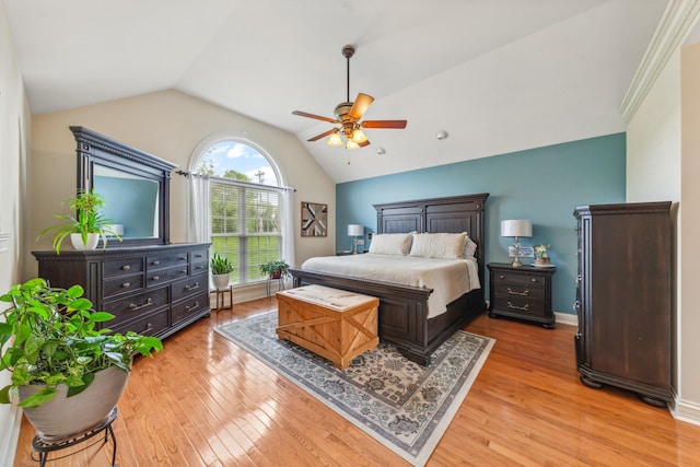 bedroom with light wood-style floors, a ceiling fan, and vaulted ceiling
