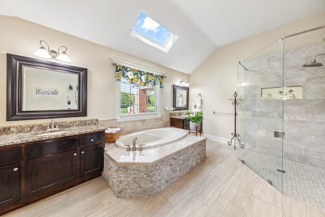 bathroom with a sink, two vanities, a shower stall, a garden tub, and lofted ceiling with skylight