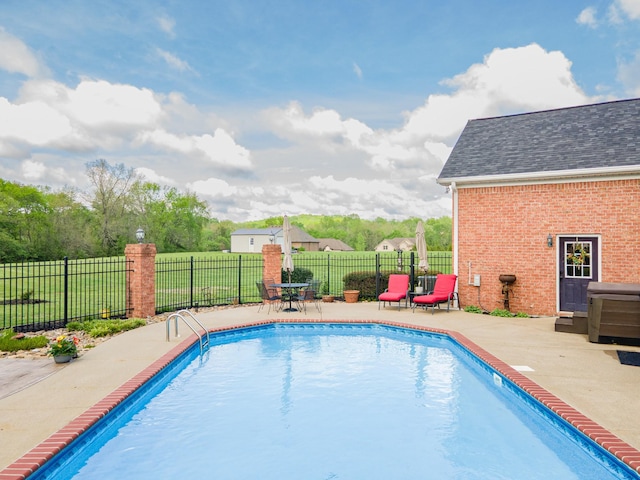 view of swimming pool with a patio, a fenced in pool, and fence