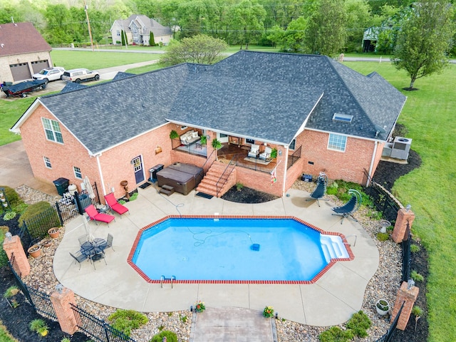 view of swimming pool with a patio, a fenced in pool, a fenced backyard, and a jacuzzi