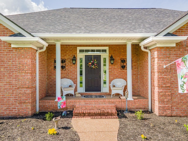 property entrance featuring a porch, brick siding, and a shingled roof