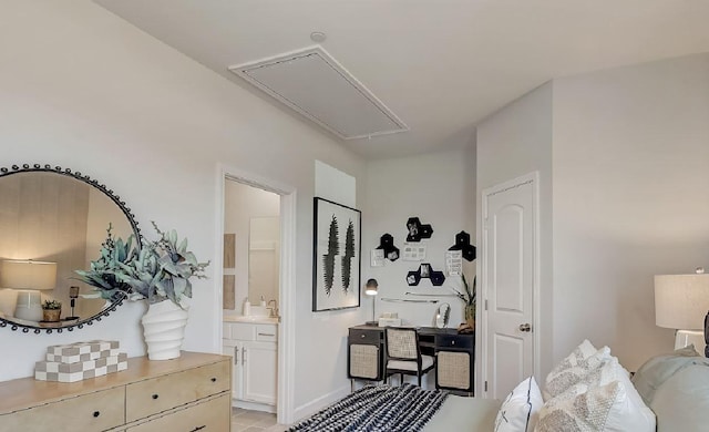 bedroom with connected bathroom, attic access, a sink, and light tile patterned floors