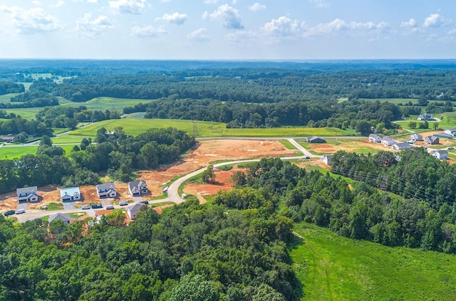 bird's eye view featuring a wooded view