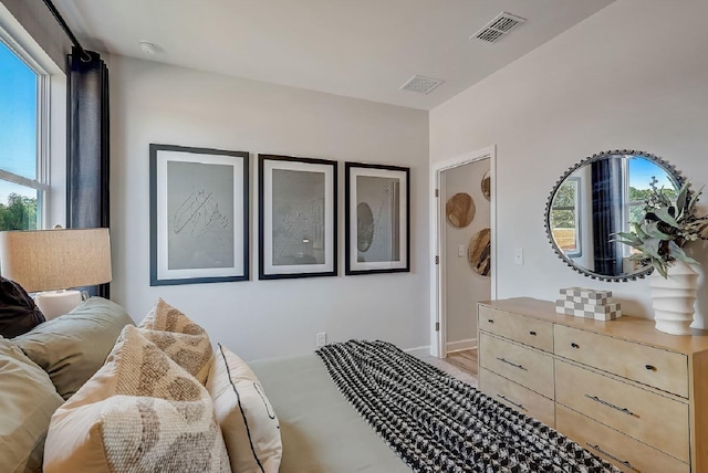 bedroom featuring baseboards and visible vents