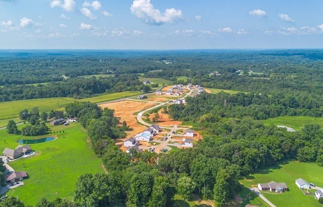 drone / aerial view featuring a wooded view