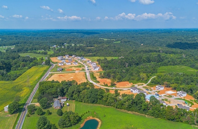 birds eye view of property with a forest view