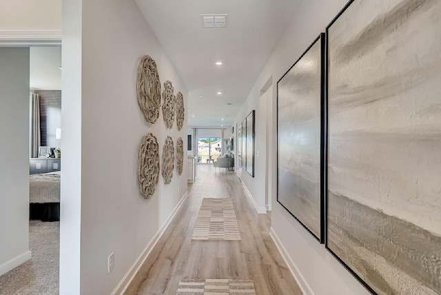 hall with recessed lighting, baseboards, visible vents, and light wood-style floors